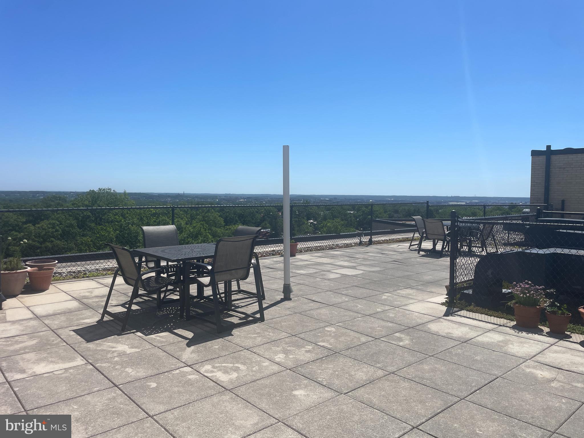 3601 Wisconsin Avenue Northwest, Unit 408 Washington, DC 20016 - Photo 17 of 17 a view of a terrace with furniture and city view