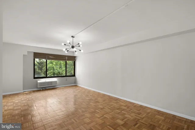 an empty room with windows and outdoor view