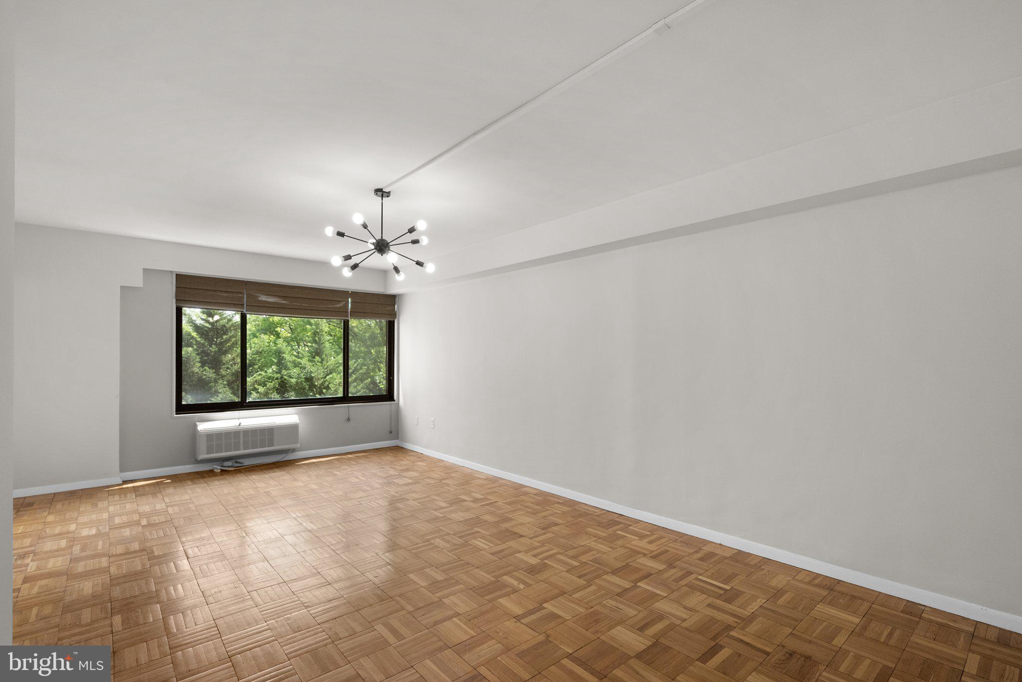 3601 Wisconsin Avenue Northwest, Unit 408 Washington, DC 20016 - Photo 5 of 17 an empty room with windows and outdoor view