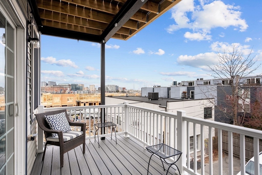 34 H Street, Unit 2L Boston, MA 02127 - Photo 17 of 20 a view of a balcony with furniture and wooden floor