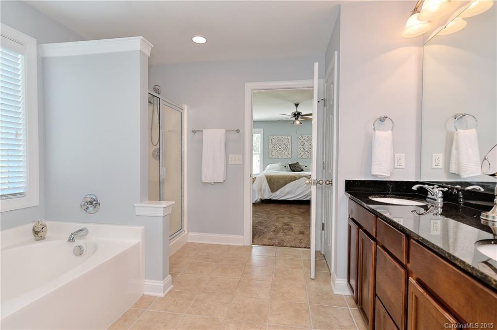 3321 Bridgewick Road Waxhaw, NC 28173 - Photo 11 of 24 a spacious bathroom with a tub sink and mirror
