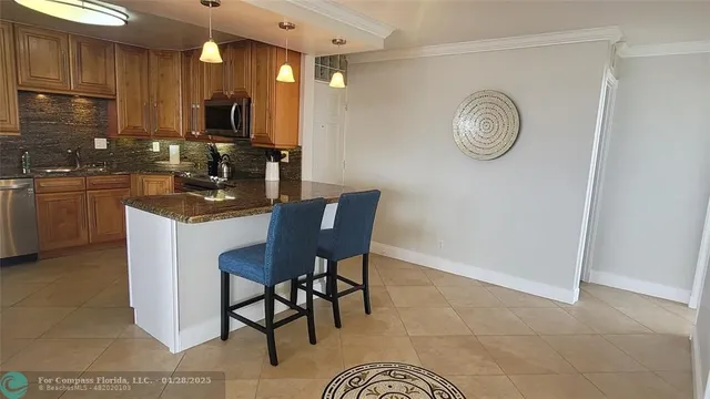 a kitchen with a sink cabinets and stainless steel appliances