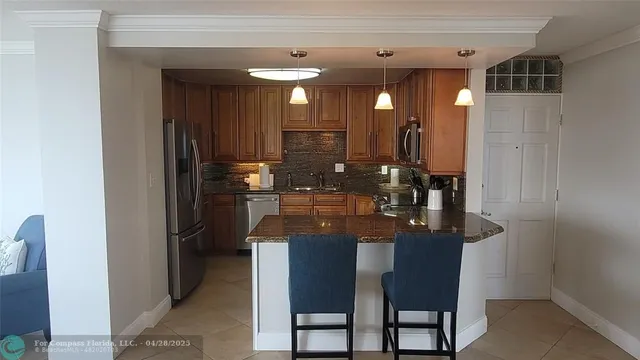 a kitchen with refrigerator and cabinets