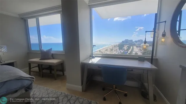 a view of a dining room with furniture and a window