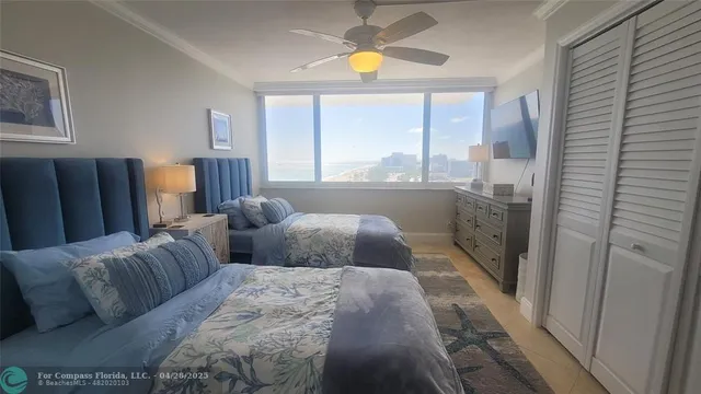 a bedroom with furniture and a large window