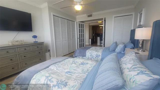 a bedroom with a large bed and a flat screen tv