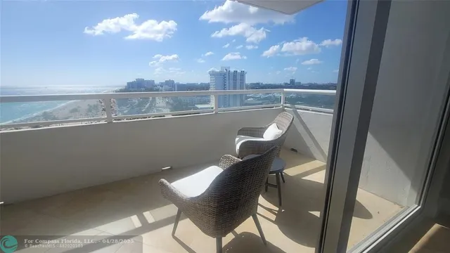 a view of a chairs and table in a balcony