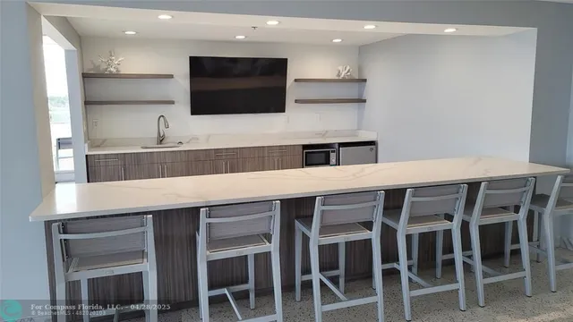 a kitchen with stainless steel appliances a stove a microwave and a sink