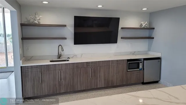 a large kitchen with a table and chairs