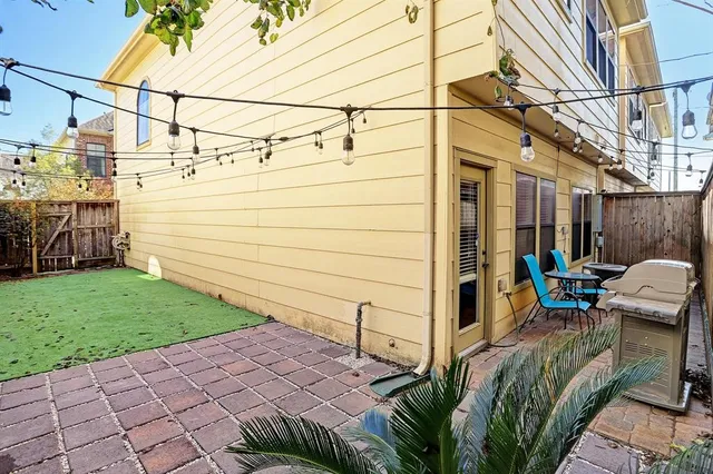 a view of a backyard with wooden fence