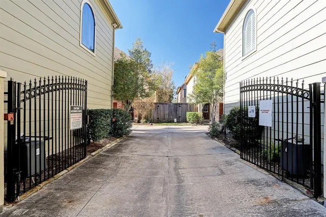 a view of a patio with table and chairs with wooden fence