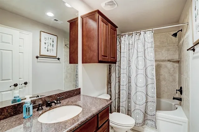 a bathroom with a sink toilet a mirror and shower