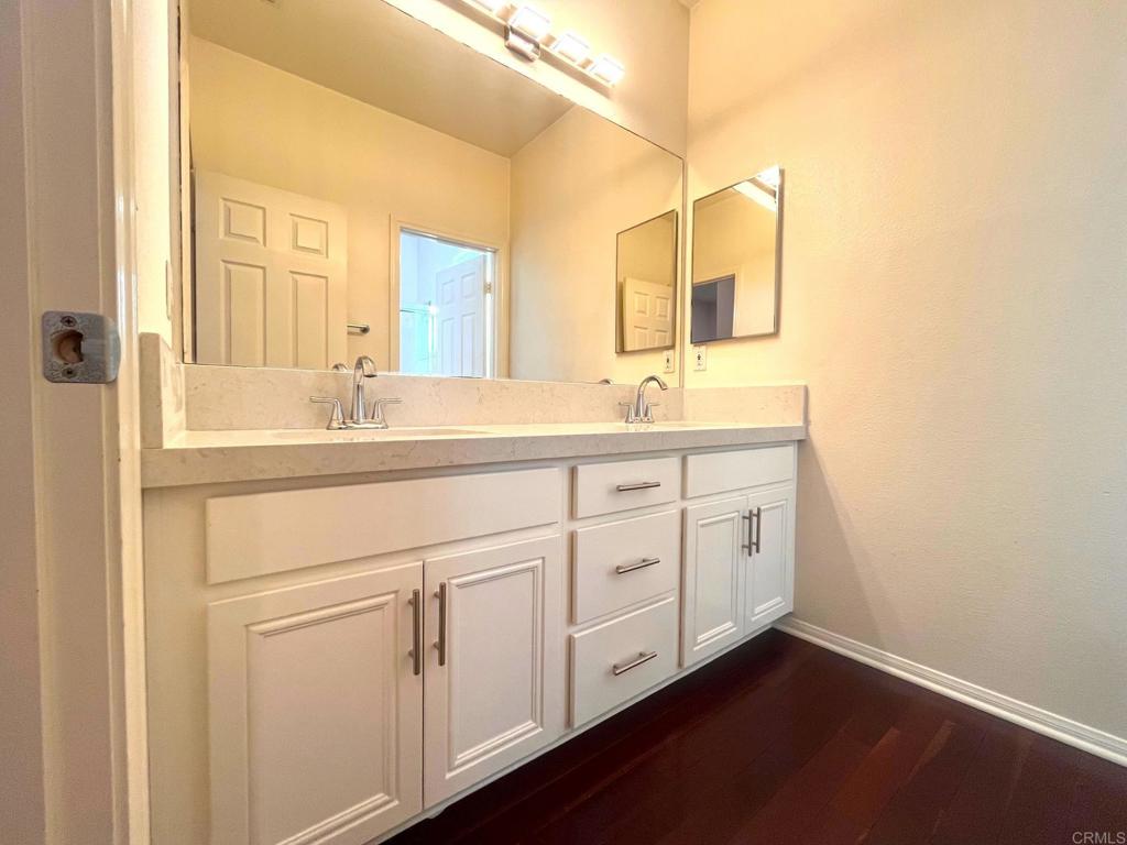 3840 Stoneridge Road Carlsbad, CA 92010 - Photo 18 of 36 a bathroom with a double vanity sink and mirror