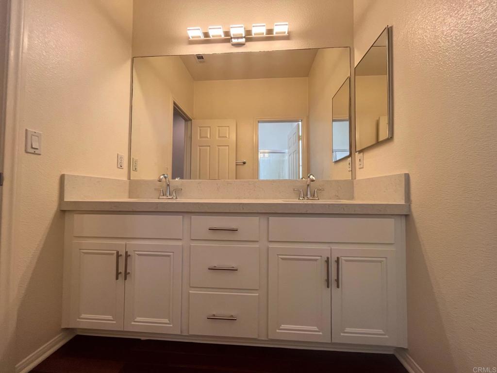 3840 Stoneridge Road Carlsbad, CA 92010 - Photo 19 of 36 a bathroom with a sink vanity and a mirror