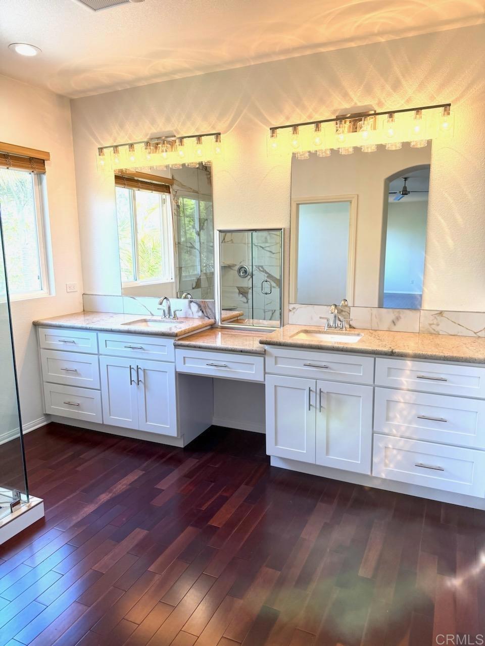 3840 Stoneridge Road Carlsbad, CA 92010 - Photo 27 of 36 a bathroom with a double vanity sink and a mirror