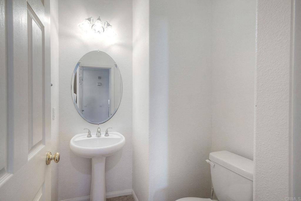 3840 Stoneridge Road Carlsbad, CA 92010 - Photo 10 of 36 a bathroom with a toilet sink and mirror