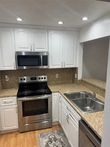 a kitchen with a stove and a sink