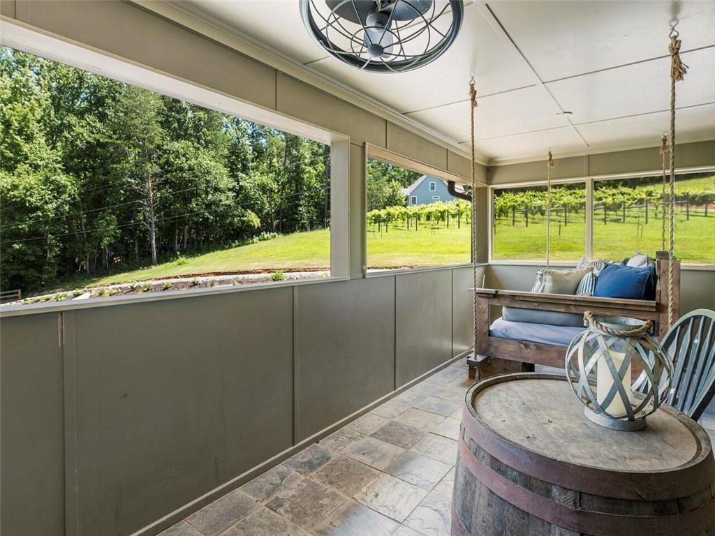 253 Happy Trails Way Jasper, GA 30143 - Photo 107 of 147 a living room with furniture and a floor to ceiling window