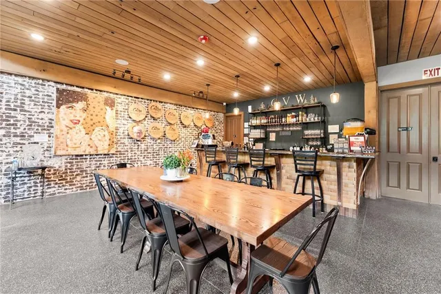 a view of a dining room with furniture large windows and wooden floor