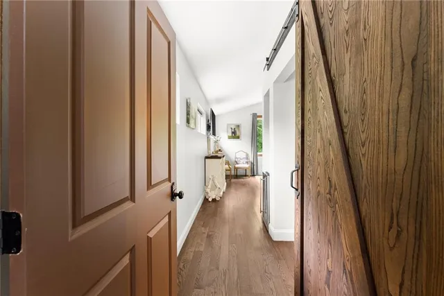 a view of a yard with plants and a barbeque