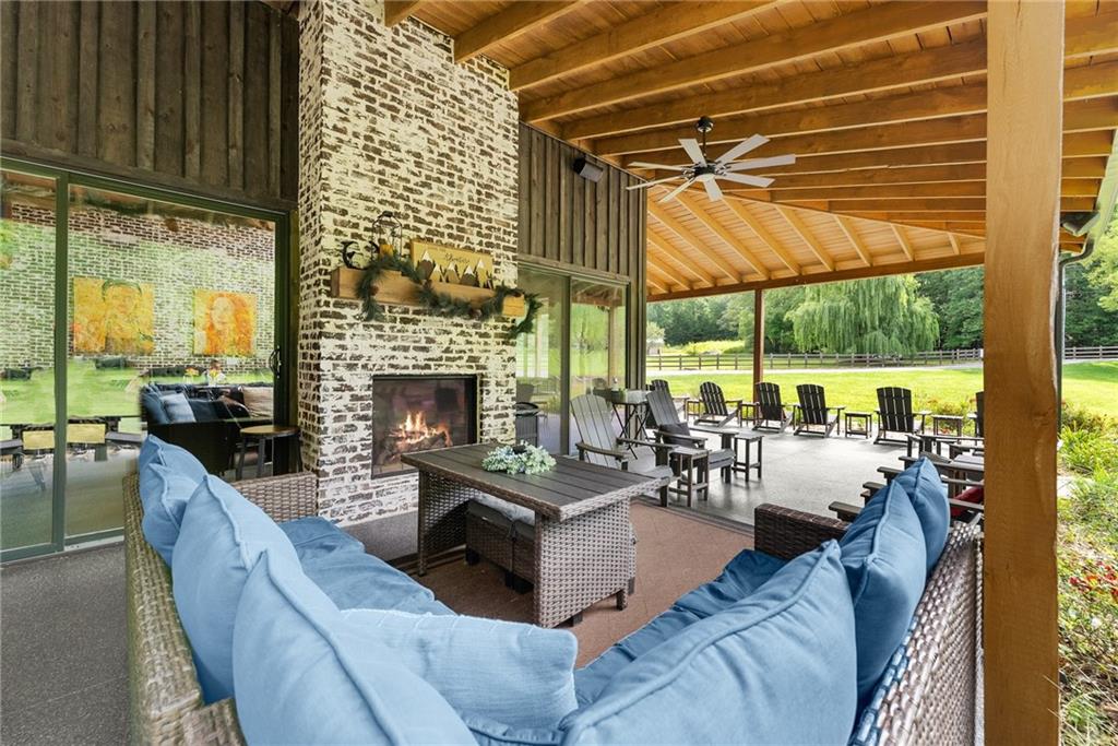 253 Happy Trails Way Jasper, GA 30143 - Photo 7 of 147 a living room with furniture a fireplace and floor to ceiling windows