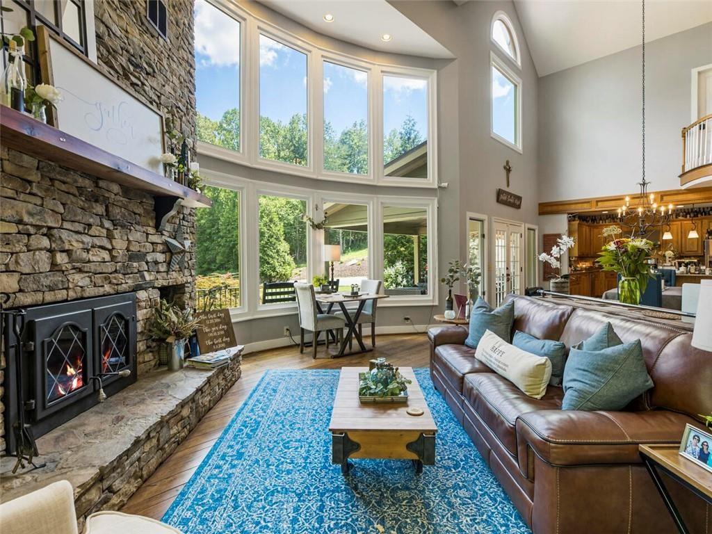 253 Happy Trails Way Jasper, GA 30143 - Photo 79 of 147 a living room with furniture fireplace and a floor to ceiling window