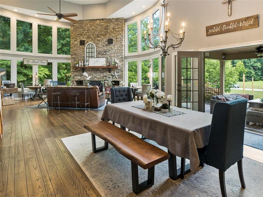 253 Happy Trails Way Jasper, GA 30143 - Photo 87 of 147 a view of a dining room with furniture large windows and wooden floor