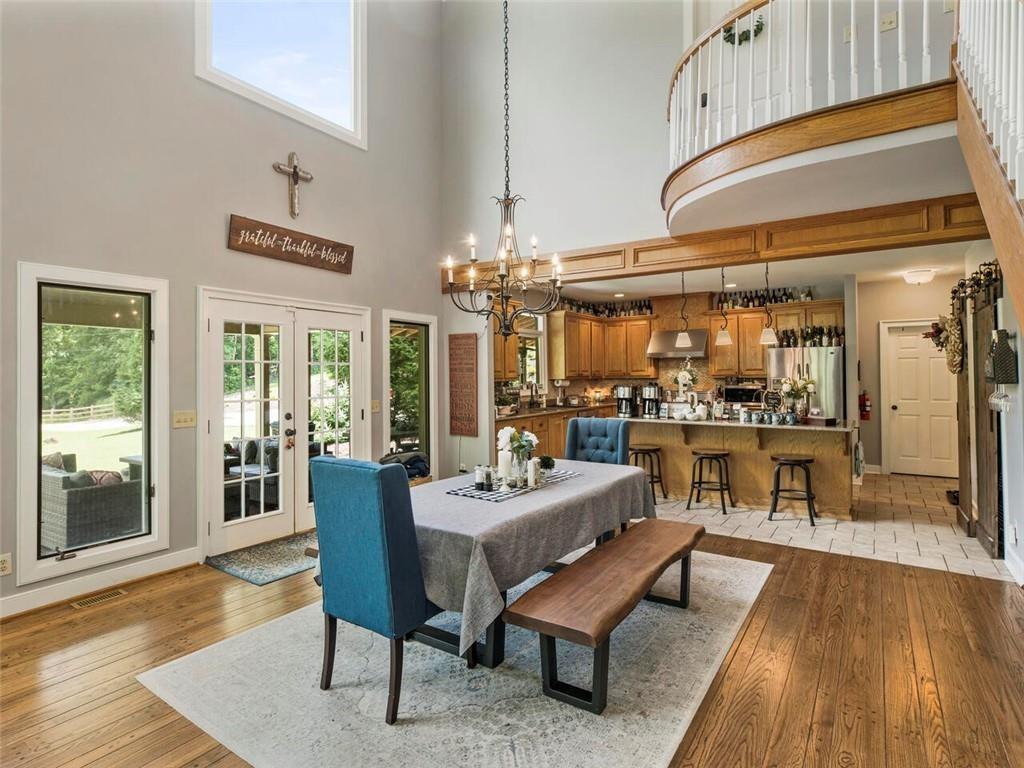 253 Happy Trails Way Jasper, GA 30143 - Photo 88 of 147 a dining room with wooden floor and large windows