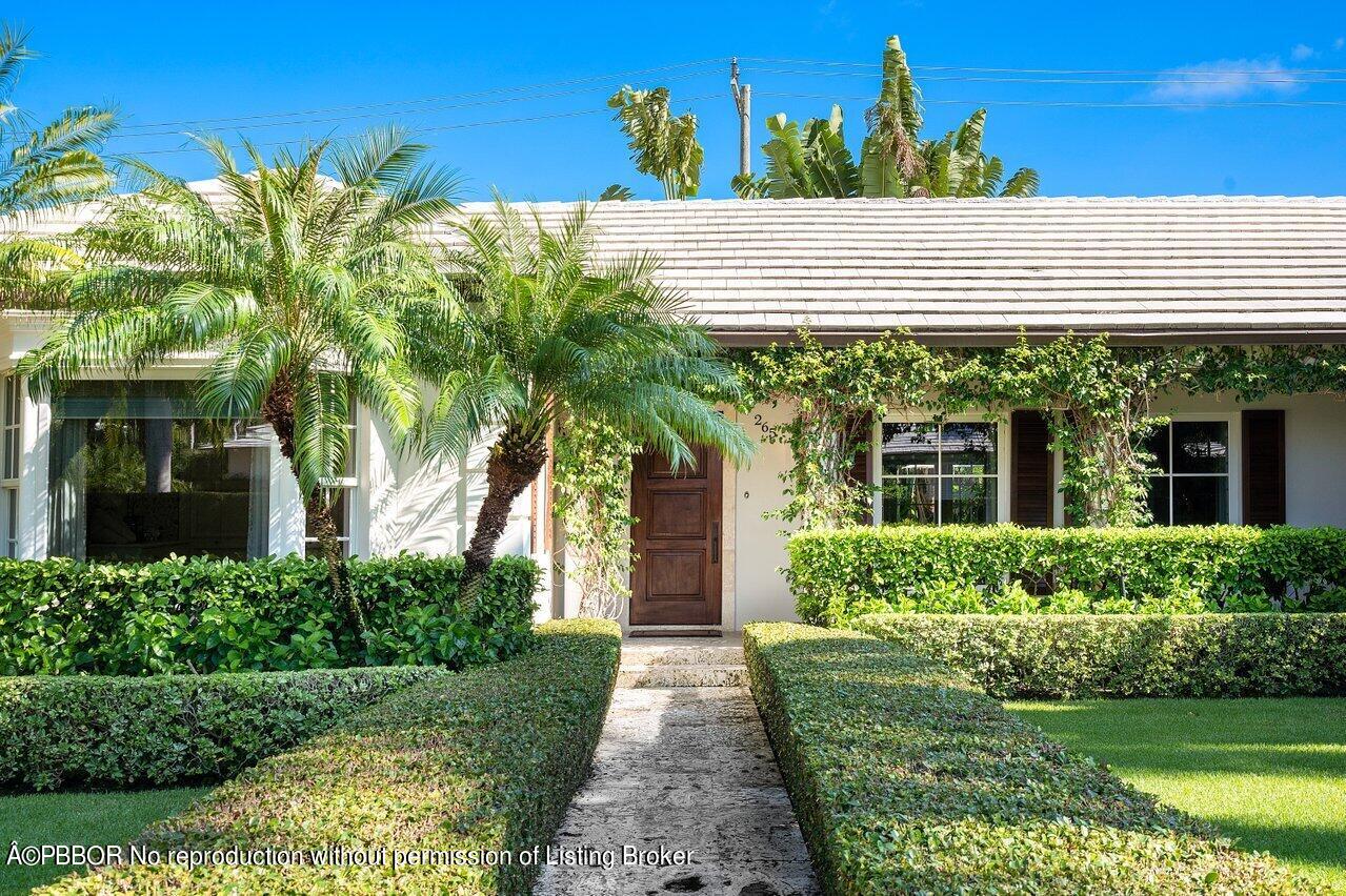 265 List Road Palm Beach, FL 33480 - Photo 2 of 39 a front view of a house with a yard