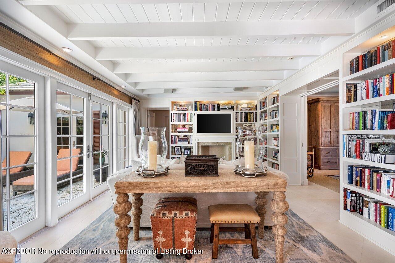 265 List Road Palm Beach, FL 33480 - Photo 14 of 39 a dining room with furniture and a book shelf