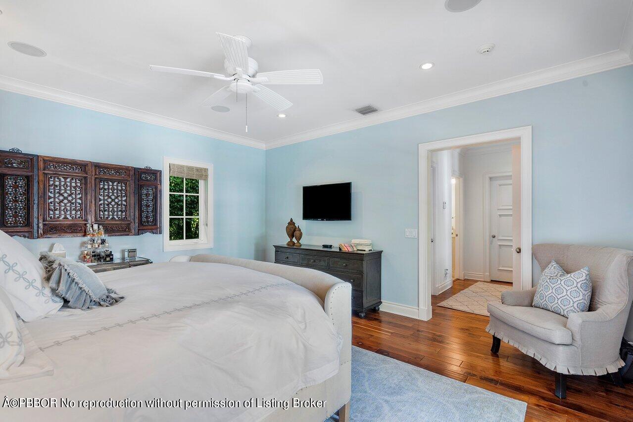 265 List Road Palm Beach, FL 33480 - Photo 17 of 39 a spacious bedroom with a bed and a flat screen tv