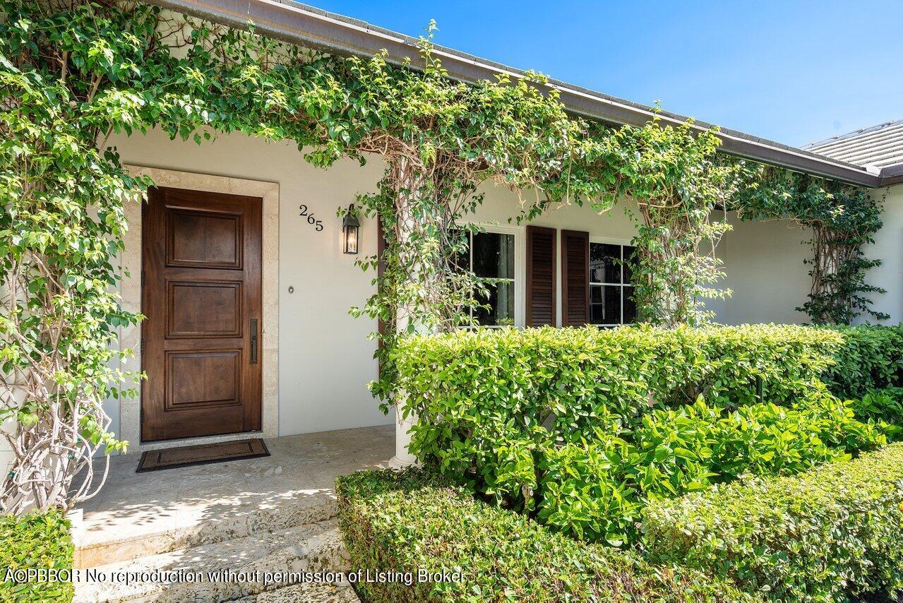 265 List Road Palm Beach, FL 33480 - Photo 3 of 39 front view of a house with a yard