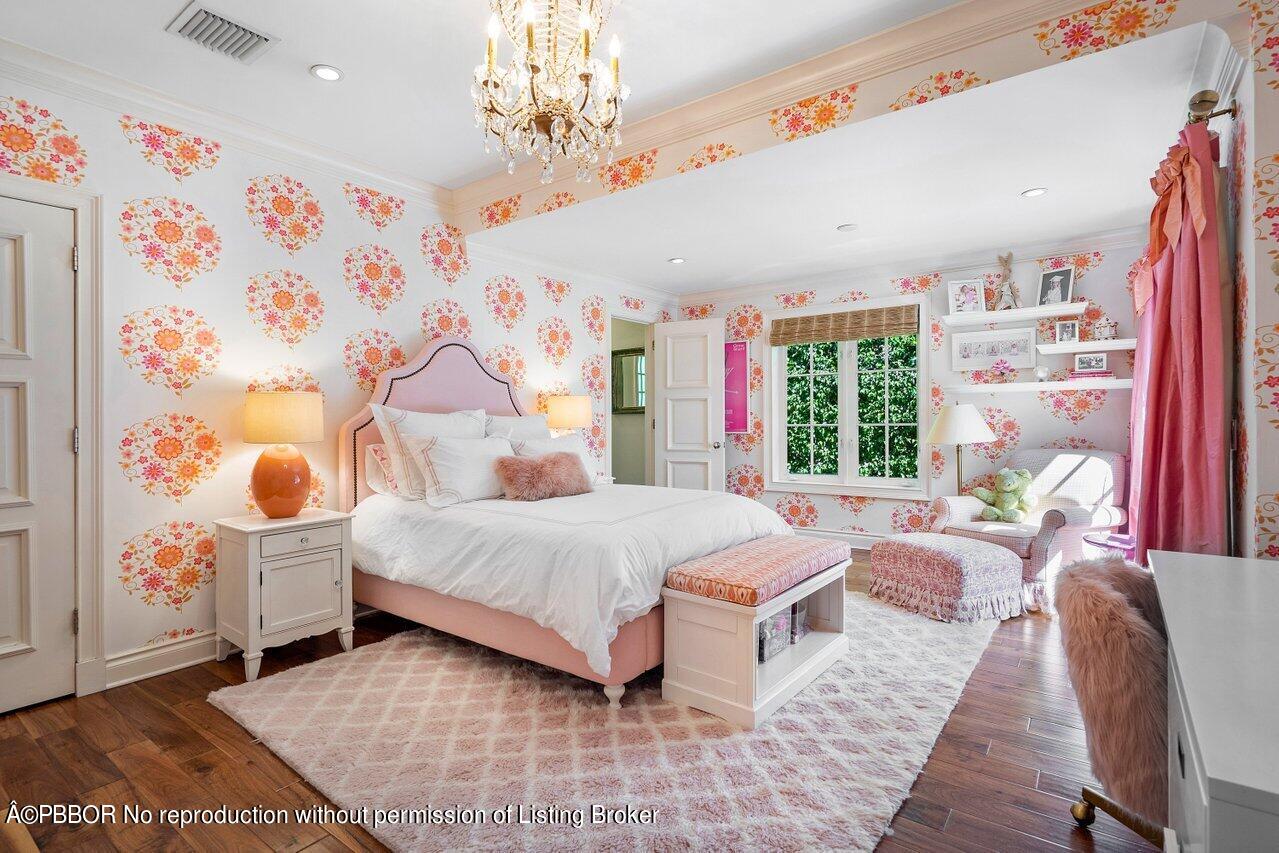 265 List Road Palm Beach, FL 33480 - Photo 21 of 39 a spacious bedroom with a large bed and a chandelier