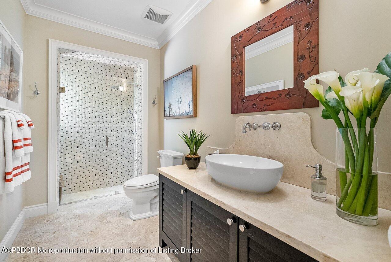 265 List Road Palm Beach, FL 33480 - Photo 29 of 39 a bathroom with a granite countertop sink a toilet and a mirror