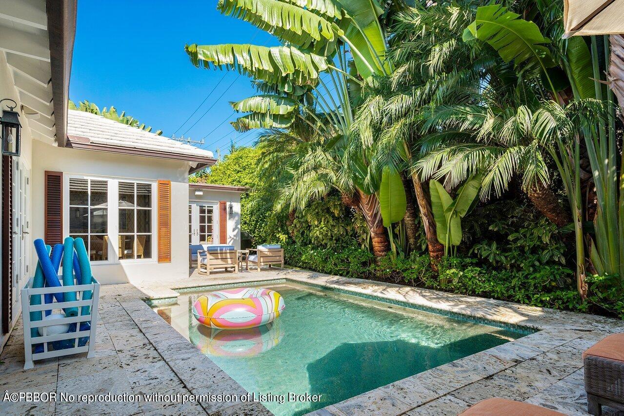 265 List Road Palm Beach, FL 33480 - Photo 31 of 39 a view of a house with swimming pool and sitting area