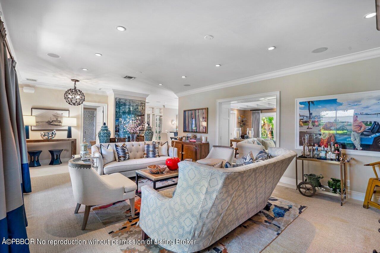 265 List Road Palm Beach, FL 33480 - Photo 5 of 39 a living room with furniture and a dining table with wooden floor