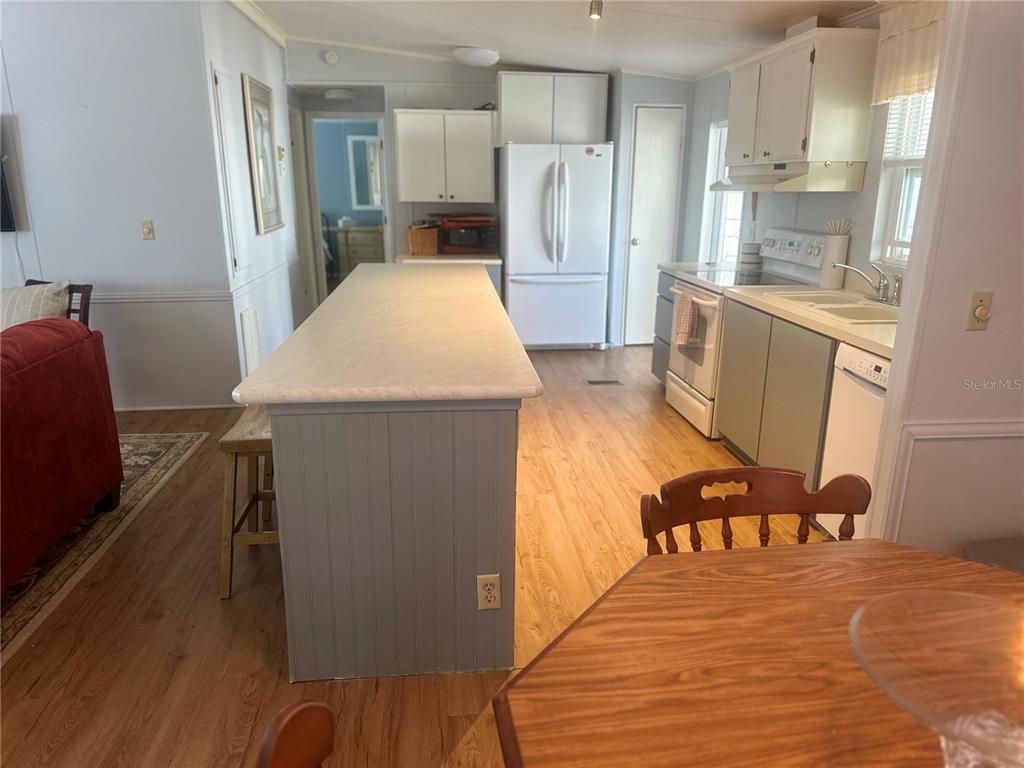 15550 Burnt Store Road, Unit 196 Punta Gorda, FL 33955 - Photo 13 of 62 a large kitchen with a table and chairs