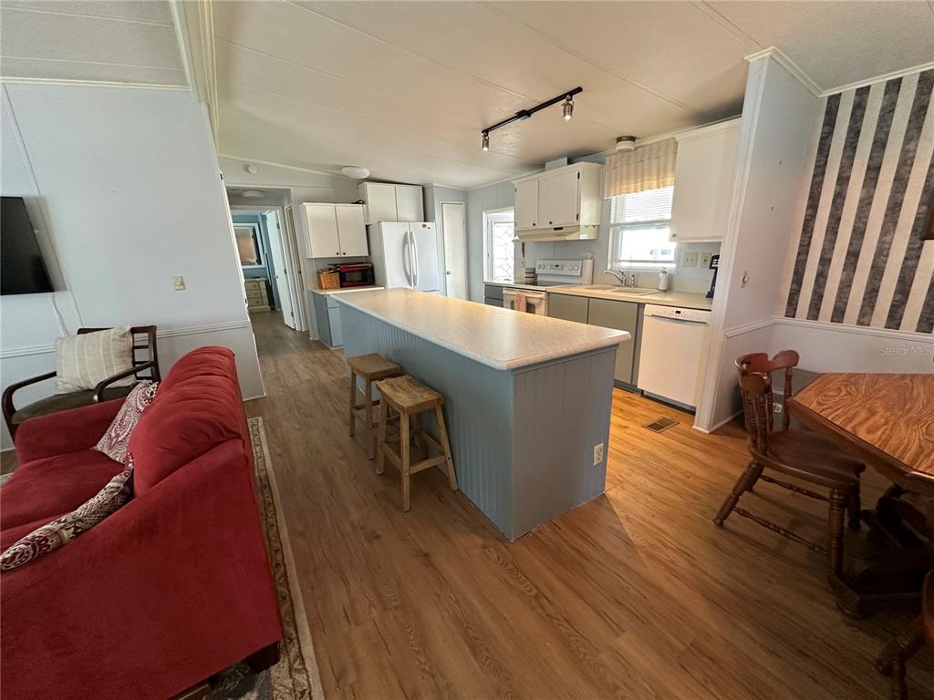 15550 Burnt Store Road, Unit 196 Punta Gorda, FL 33955 - Photo 14 of 62 a living room with furniture a wooden floor and a sink
