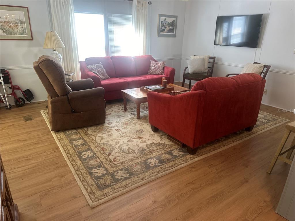 15550 Burnt Store Road, Unit 196 Punta Gorda, FL 33955 - Photo 16 of 62 a living room with furniture and a flat screen tv