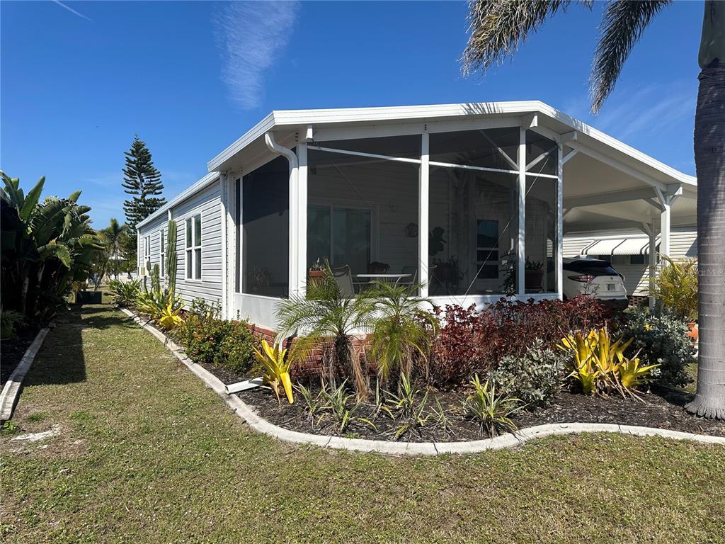15550 Burnt Store Road, Unit 196 Punta Gorda, FL 33955 - Photo 2 of 62 a view of a house with potted plants