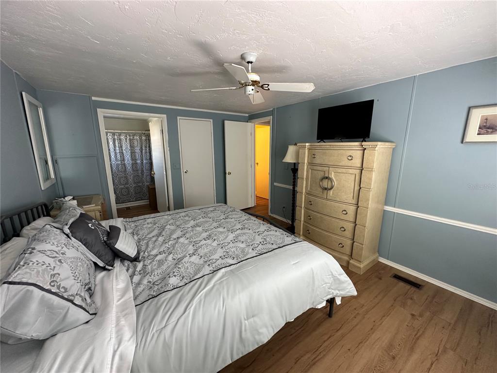 15550 Burnt Store Road, Unit 196 Punta Gorda, FL 33955 - Photo 22 of 62 a bedroom with a bed and a flat tv screen on dresser