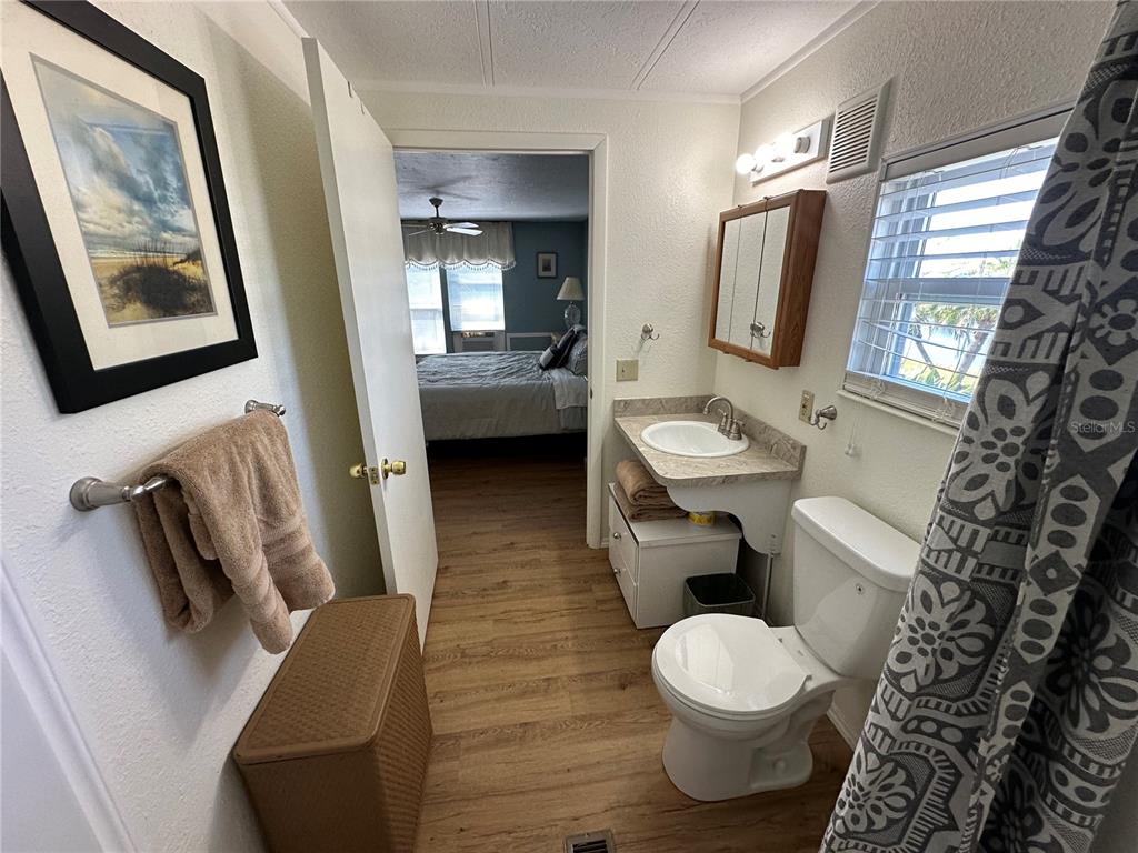 15550 Burnt Store Road, Unit 196 Punta Gorda, FL 33955 - Photo 26 of 62 a bathroom with a toilet sink and mirror