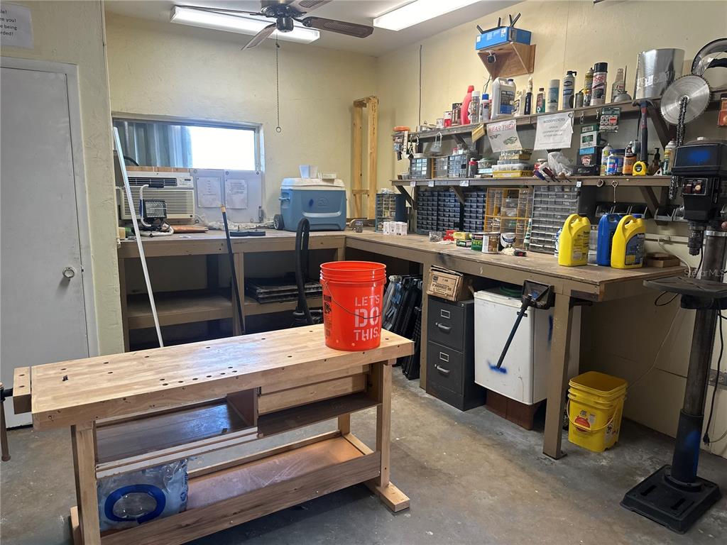 15550 Burnt Store Road, Unit 196 Punta Gorda, FL 33955 - Photo 59 of 62 a kitchen with stainless steel appliances kitchen island granite countertop a table chairs in it and a window