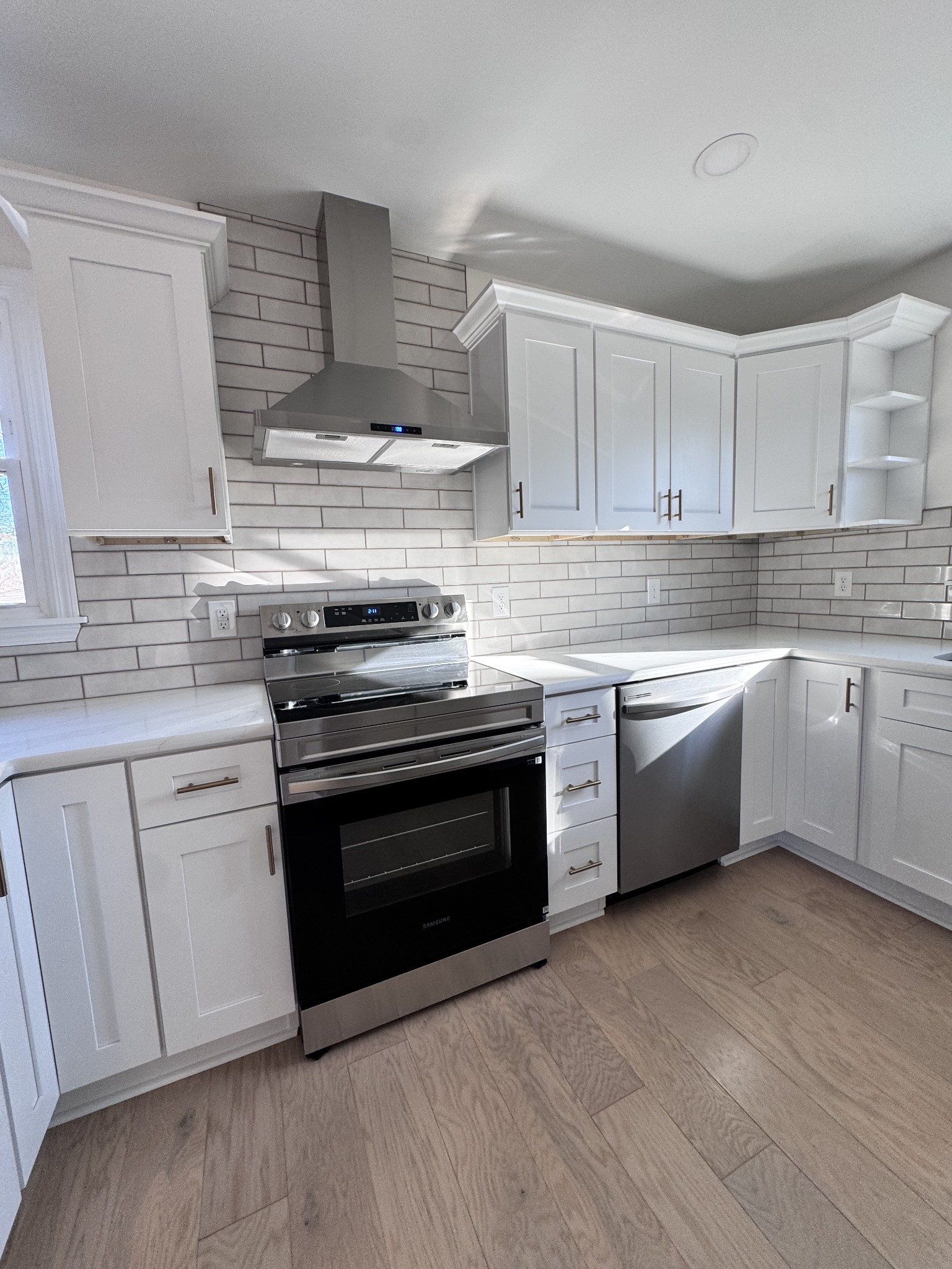 331 Oriel Avenue Nashville, TN 37210 - Photo 12 of 49 a kitchen with stainless steel appliances a stove a sink and white cabinets