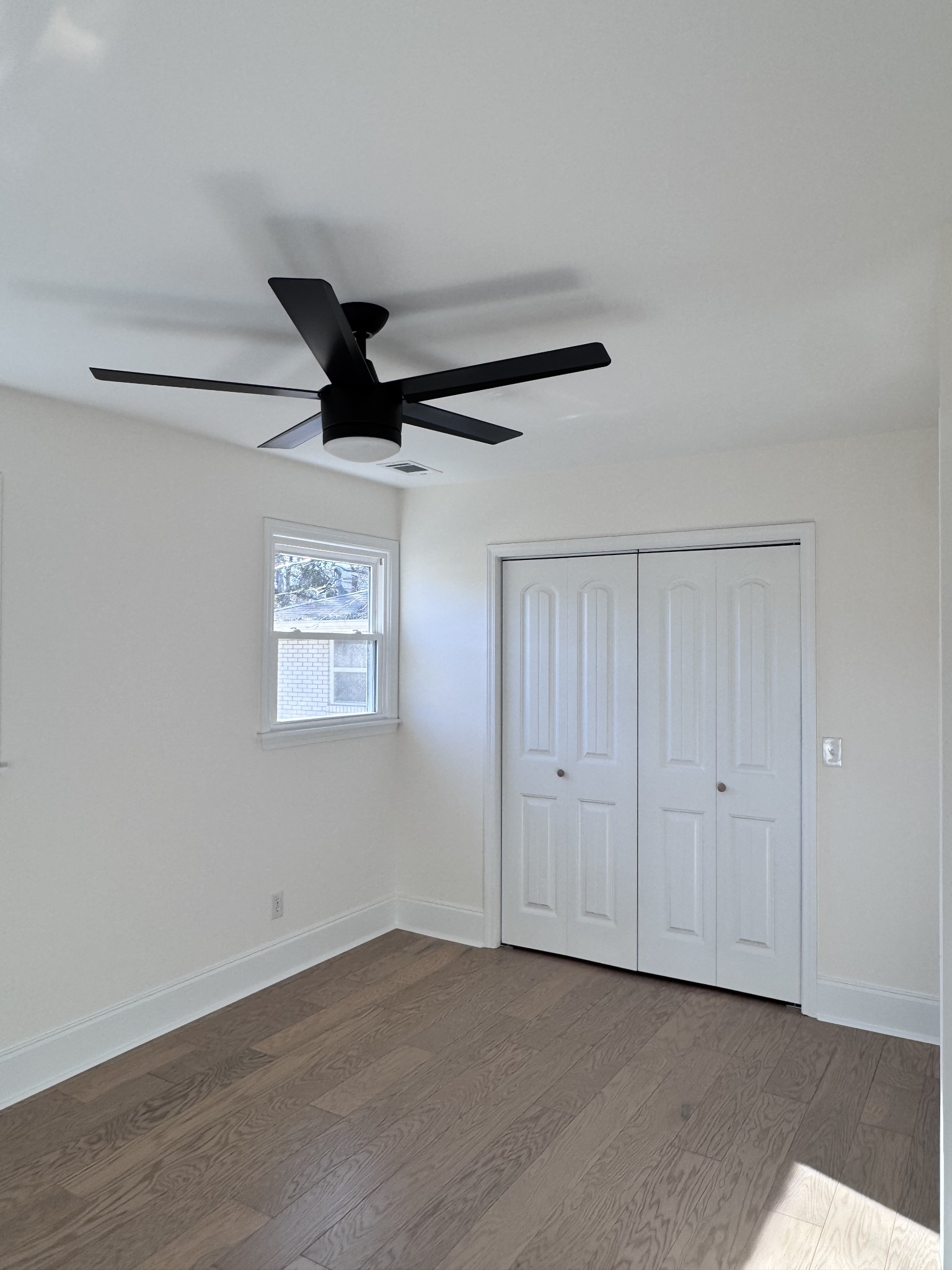 331 Oriel Avenue Nashville, TN 37210 - Photo 15 of 49 an empty room with a ceiling fan and wooden floor
