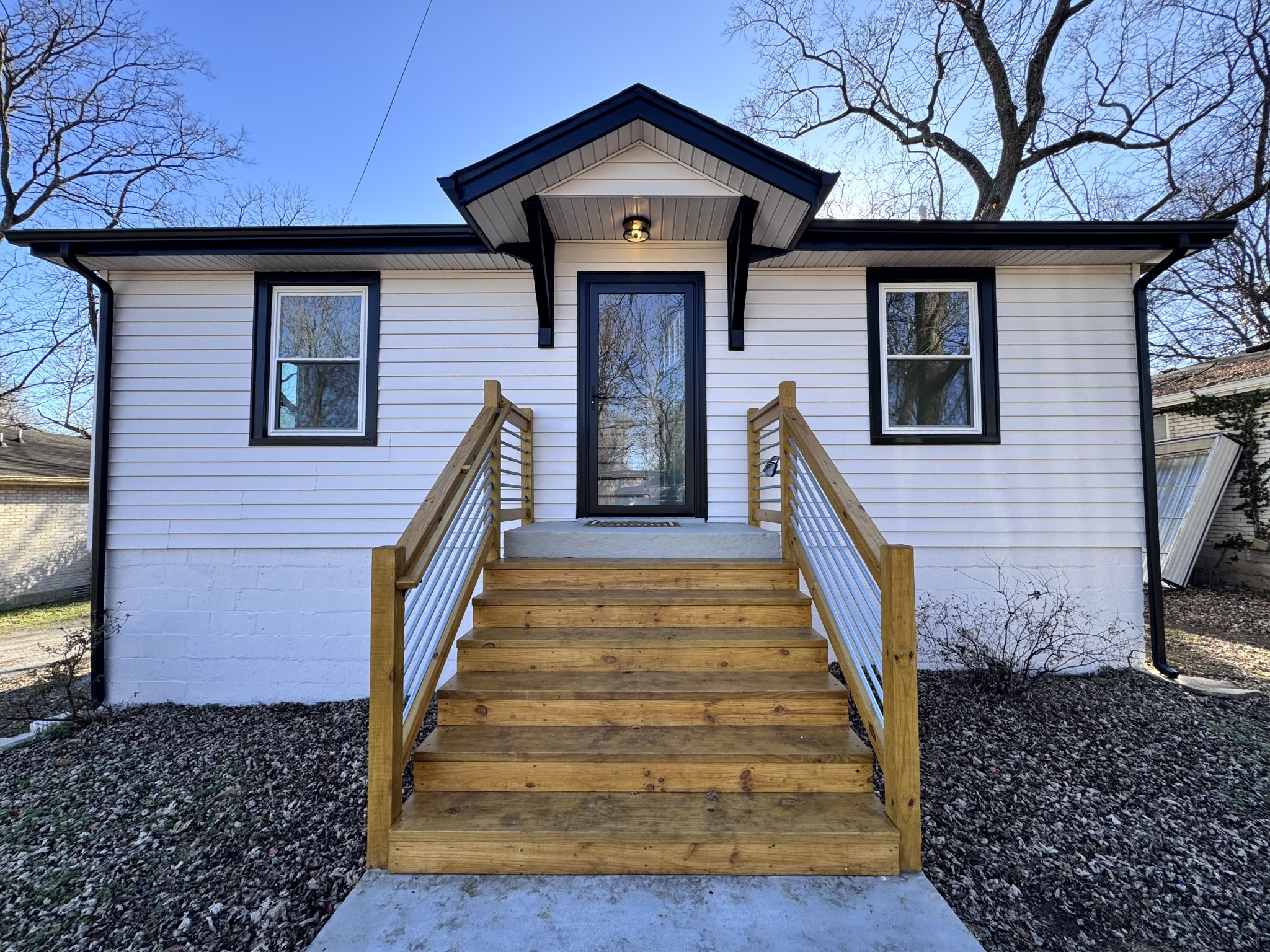 331 Oriel Avenue Nashville, TN 37210 - Photo 2 of 49 a front view of a house with wooden stairs and a large tree
