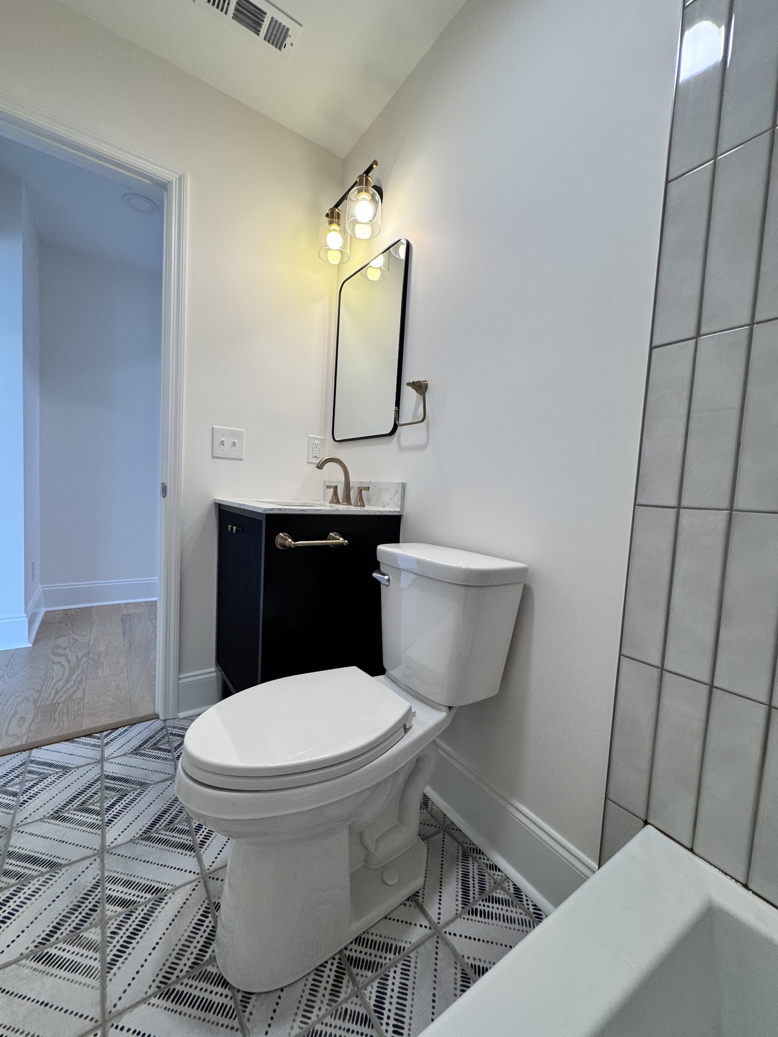 331 Oriel Avenue Nashville, TN 37210 - Photo 23 of 49 a bathroom with a toilet sink and mirror
