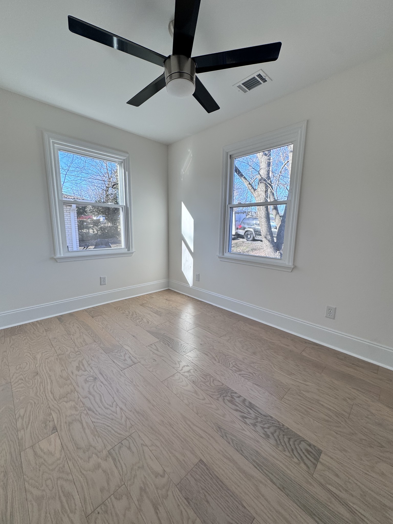 331 Oriel Avenue Nashville, TN 37210 - Photo 25 of 49 a view of an empty room with a window and a painting on the wall