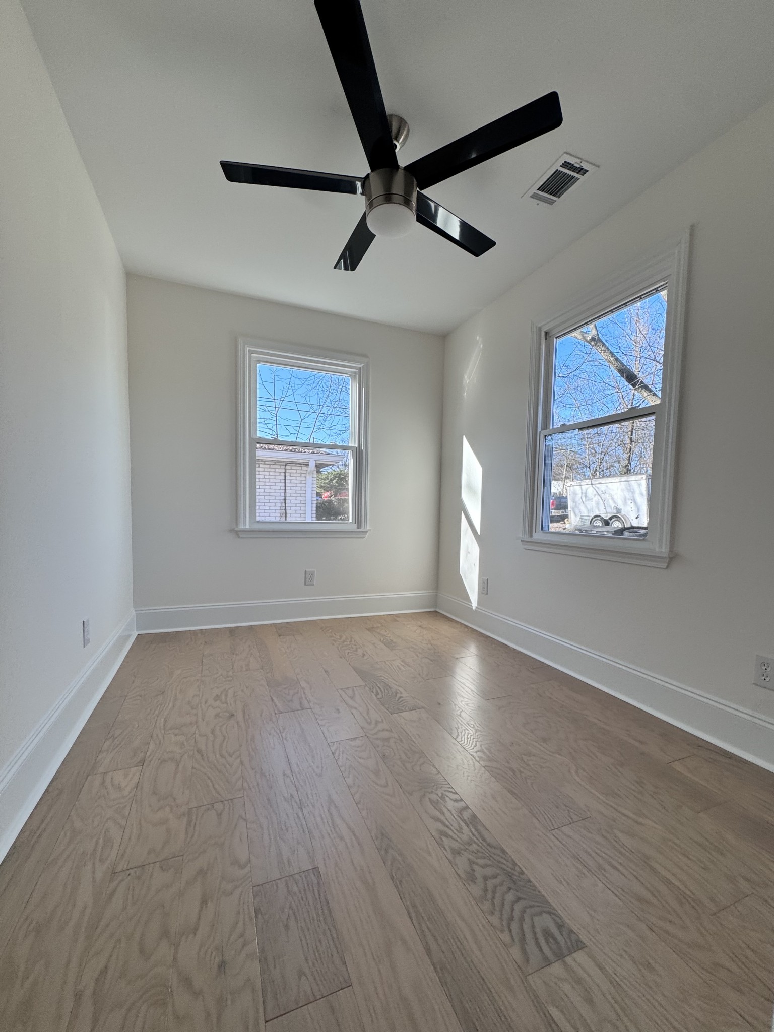 331 Oriel Avenue Nashville, TN 37210 - Photo 26 of 49 a view of an empty room with a window and wooden floor