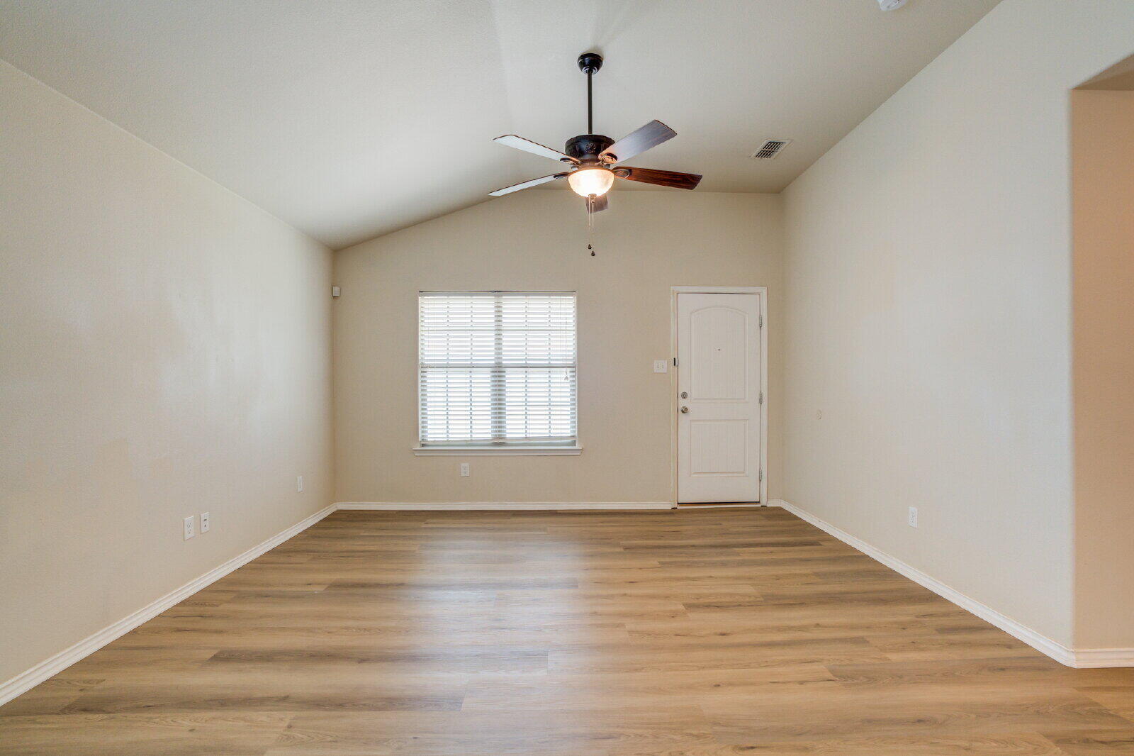 6921 95th Street Lubbock, TX 79424 - Photo 13 of 32 wooden floor in an empty room with a window